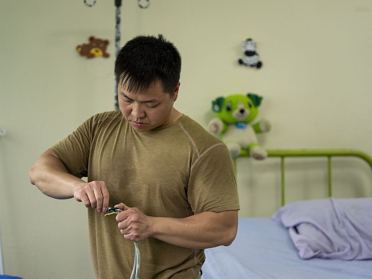 Technician preparing copper piping for an AC connection