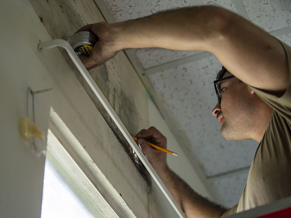 Technician marking the wall to mount an AC indoor unit